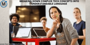 A group of people in a discussion, with a woman in the foreground thoughtfully holding a pen. Laptops and a screen are visible in the background.